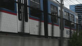Pacing alongside a Metro train in an Asian City, HD stock video clip