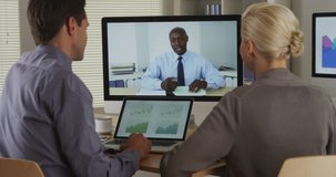 Black business manager remotely talking to employees