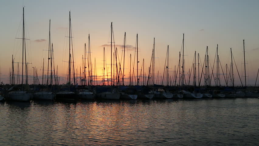 Boats during sunset dock in the marine of the city Ashdod, Israel