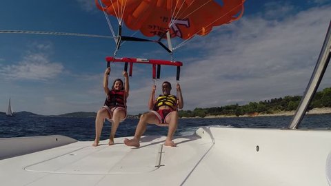 BIOGRAD, CROATIA - AUGUST 26: A couple parasailing 200 meter high above the Mediterranean sea. Para sailing or parascending is a new extreme sport. On August 26, 2014, in Biograd, Croatia