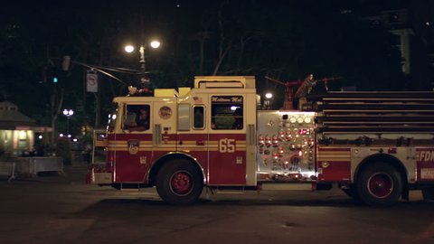 NEW YORK - AUGUST 9, 2014: firetruck at night in 4K in New York. The FDNY provides fire protection and emergency medical services to the five boroughs of New York City.