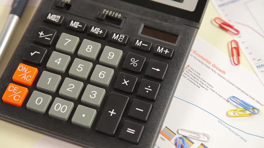 Business man working with calculator in the office. Account on a calculator.