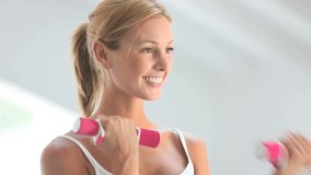 Fitness girl exercising with dumbbells