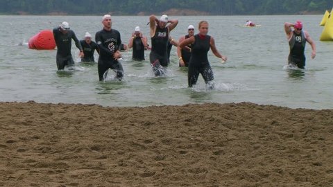 WAYNESVILLE - JULY 5: Swimmers (names withheld) from Ohio exiting water during the swim leg of the Ohio Challenge Triathlon held at Caesar Creek State Park July 5, 2009 in Waynesville, OH. 