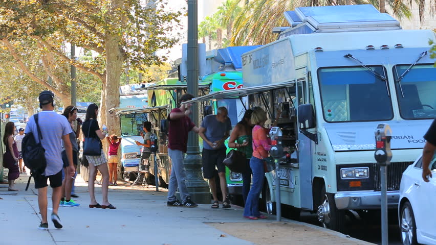 Los Angeles, California - September 5th, 2014: Tourists Purchasing Meals at Food Trucks in Museum Row of Miracle Mile, September 5th, 2014 in Los Angeles, California.