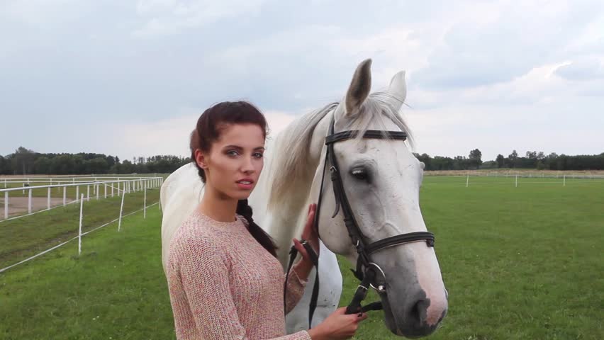 Young woman with horse, close up portrait