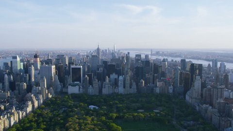 Aerial view of Central Park in New York City, United States of America. Helicopter flying over the green area of NYC. Sunset over iconic scene.