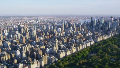 Aerial view of Central Park in New York City, United States of America. Helicopter flying over the green area of NYC. Sunset over iconic view.
