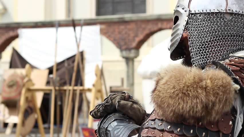 Standing fully equiped medieval warrior with leather armor with fur.