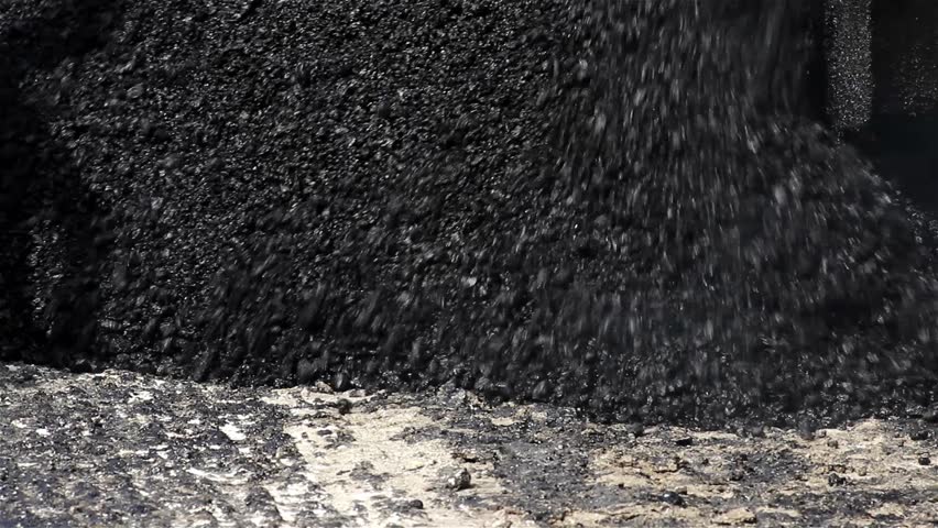 Close up asphalt. Asphalt paver machine during road construction. Tracked machines for paving apply asphalt to road. Spillage of asphalt on the street. Pouring blacktopping. Road work, street repair. Royalty-Free Stock Footage #7248445