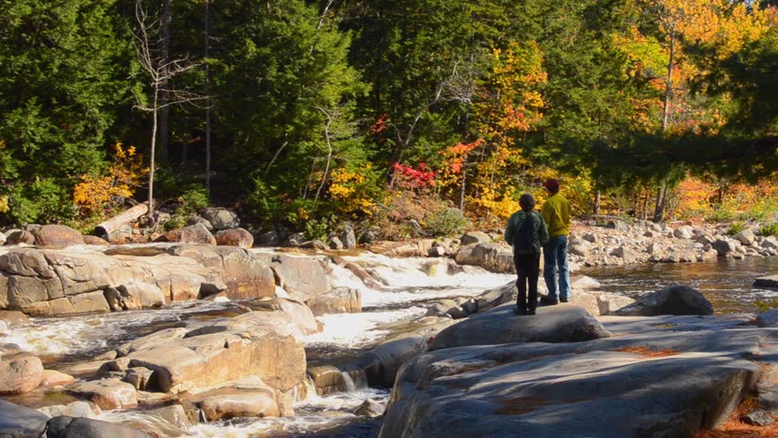 Kancamagus Highway New Hampshire near Conway Swift River  Lower Falls with couple with rocks and fall foliage in Northern New England in October color  10