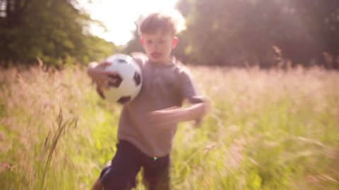 Young Boy going to Play outside with Soccer Ball