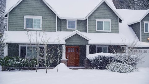 Home exterior in snow storm