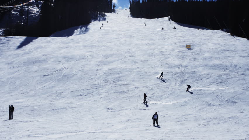 Time lapse of hundreds of skiers skiing down a mountain in the Rocky Mountains