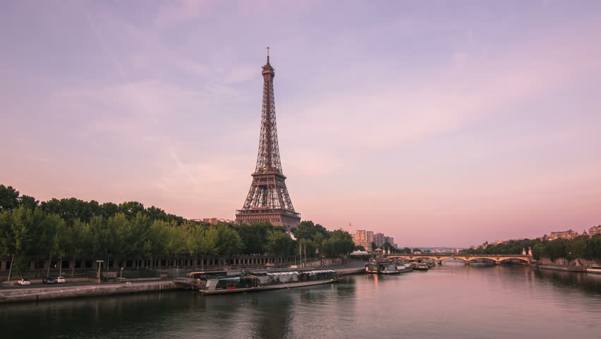 Eiffel tower seen from a bridge on the seine river,timelapse from night to day,paris wakes up as the sun rise up | Shutterstock HD Video #7258225