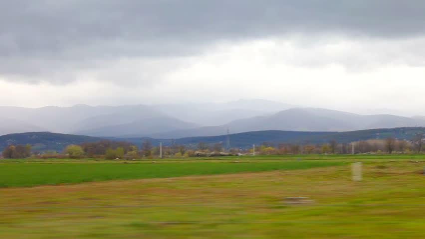 Car driving cloudy sky and mountains cut1