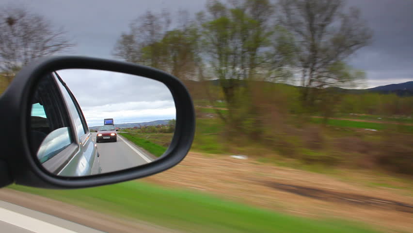 Car driving and stop looking through mirror cloudy sky