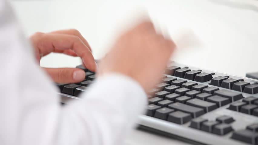 close shot of a female's hands typing on a keyboard 