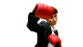 Young businesswoman punching with boxing gloves in slow motion - Powered by Shutterstock - Get 15% off with code: PIKWIZARD15