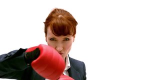 Young businesswoman punching with boxing gloves in slow motion - Powered by Shutterstock - Get 15% off with code: PIKWIZARD15