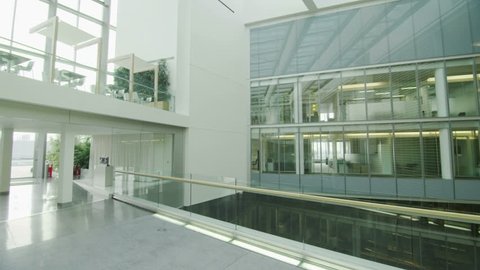 Interior view of modern office building with glass partitions & central atrium