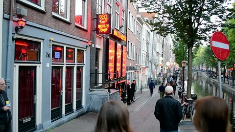 AMSTERDAM - SEP 10: Red Light District on September 10, 2014 in Amsterdam, Netherlands. There are near 500 red windows in the city rented by prostitutes and about 1000 working girls.