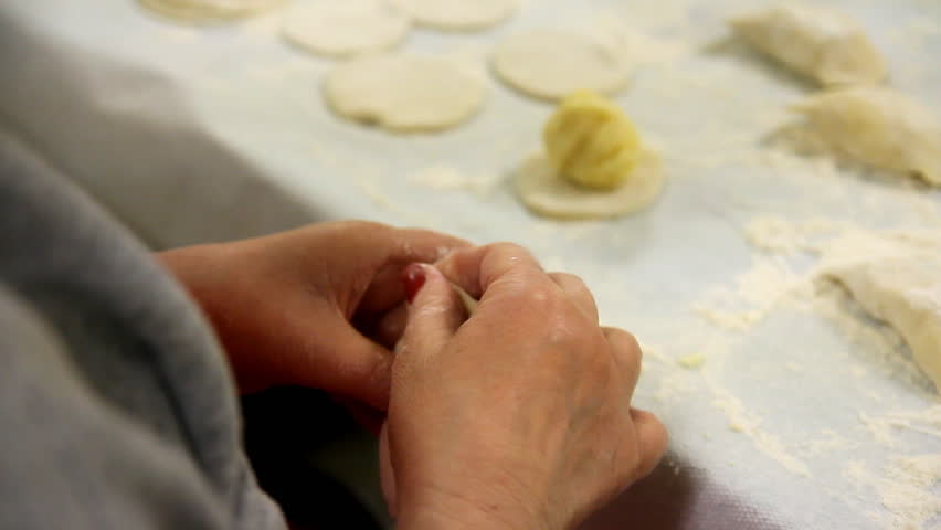 Volunteers prepare and pinch pierogies to be sold at a church fundraiser.