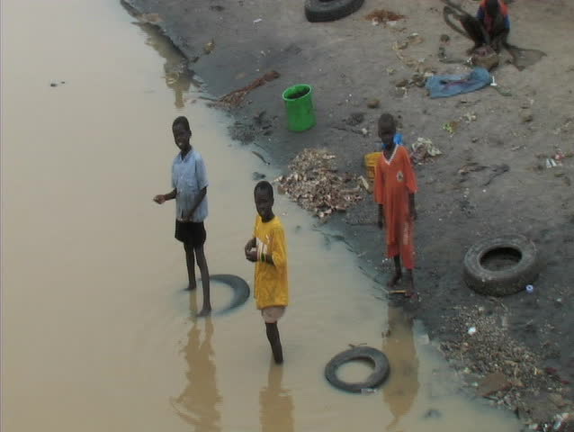3 kids standing in the water in senegal africa