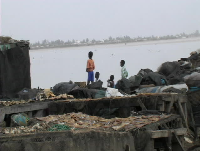 Kids watching river at a fish market in senegal africa