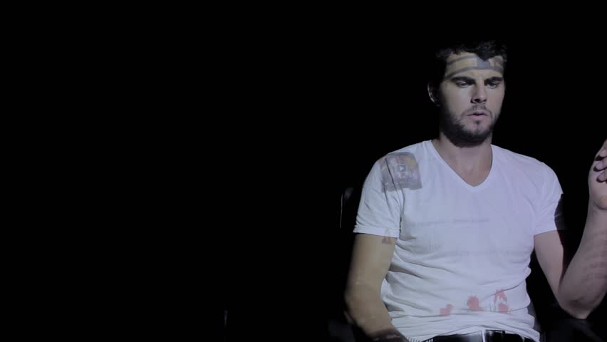 A man is looking at his facebook news feed and smiles. 