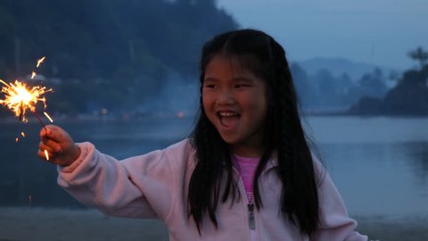 Girl with sparkler on Fourth of July 스톡 비디오
