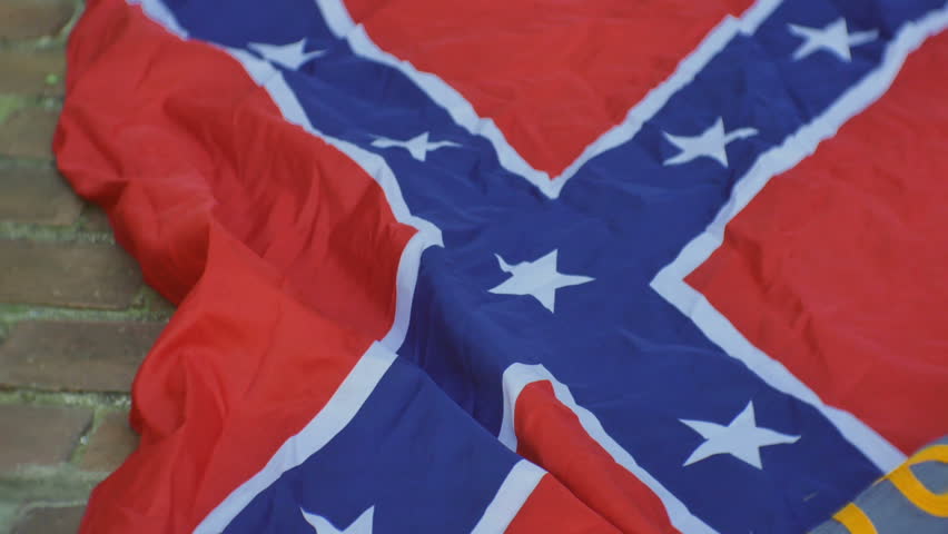 Rebel uniform and a confederate flag