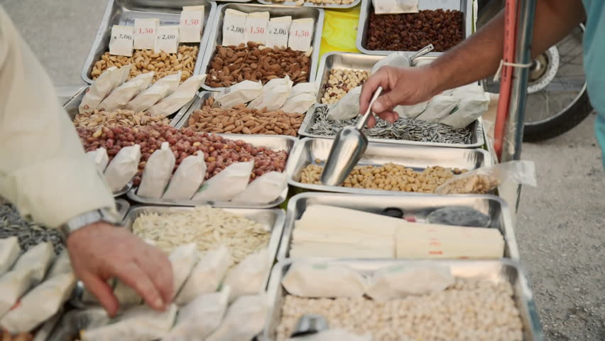 Customer choosing purchasing goods off a street vendor
