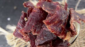 Portion of Beef Jerky (seamless loopable; with salt and pepper as close-up video)