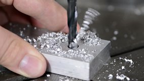 Short clip of drilling into a piece of metal (close-up video)