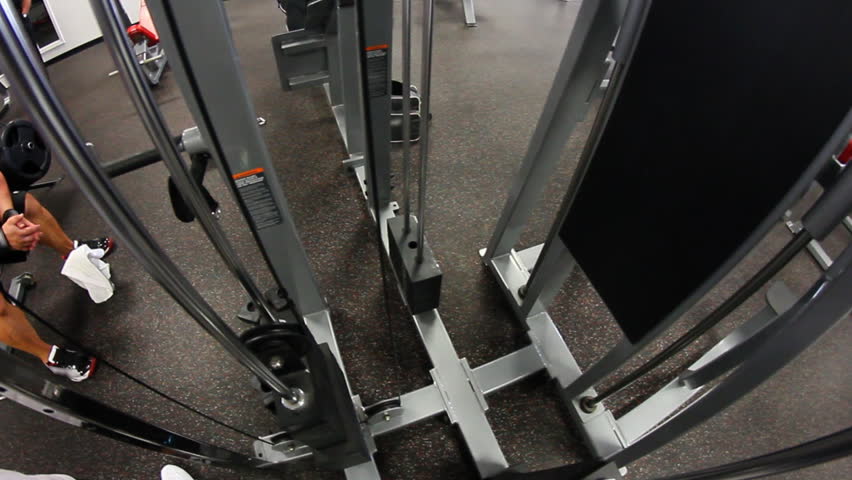 Lifting weights in a gym.  Fisheye lens.