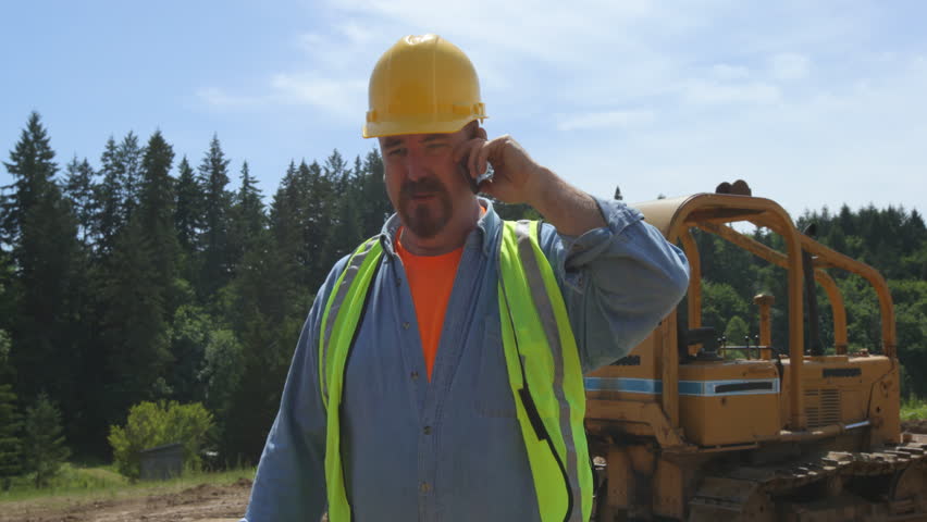 Blue collar worker walking and talking on phone