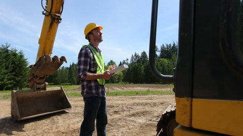 Worker inspecting excavation equipment