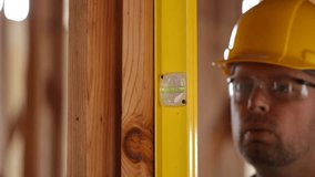 Construction worker checking level - Powered by Shutterstock - Get 15% off with code: PIKWIZARD15