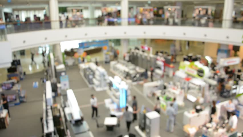 defocused crowd of walking people in the shopping mall center