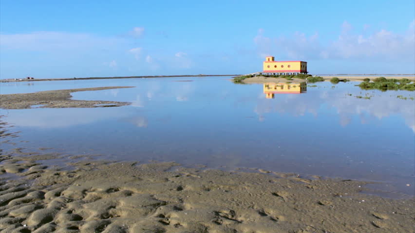 Time-lapse landscape of historic life-guard building at Fuseta fishing town, Ria Formosa conservation park, Algarve. Portugal