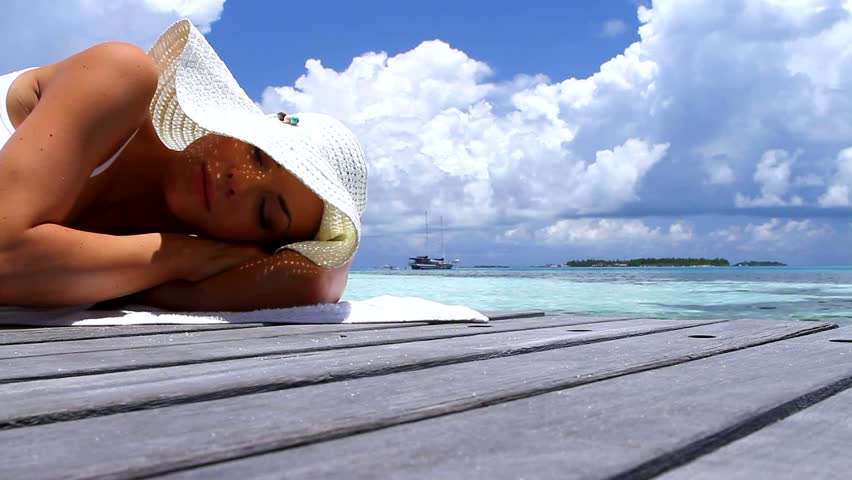 Beautiful woman resting near water at Maldives 