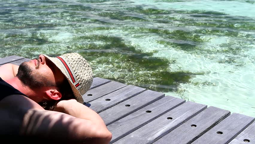 Handsome man resting near water at Maldives 