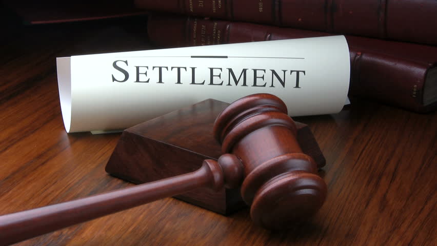 Judge pounds gavel pronouncing a settlement