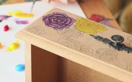 Close up video of a girl painting a wooden box