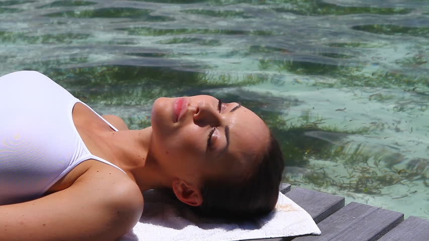 Beautiful woman resting near water at Maldives 