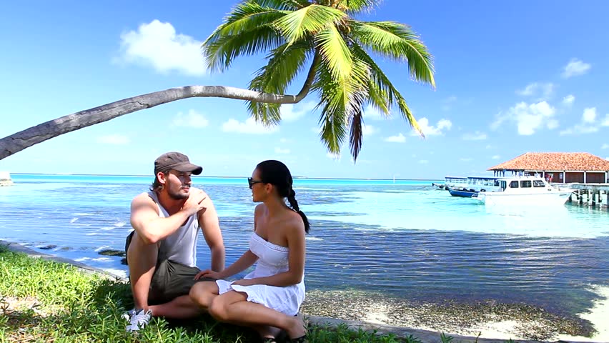 Romantic couple resting at Maldives seaside 