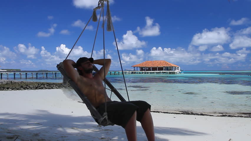 Handsome man resting near water at Maldives 