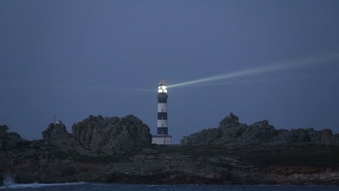 Creach lighthouse illuminated in evening, the most powerful in the world, Ushant island (aka Ouessant), Brittany, France
