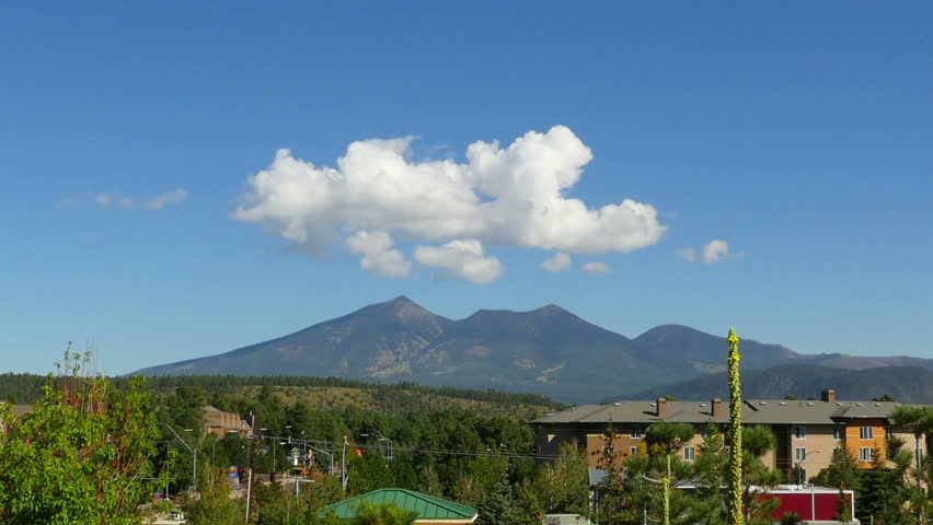 The beginning of a large monsoon storm in Flagstaff, Arizona, starts with a cumulus cloud over the highest mountain in Arizona, Humphreys Peak. HD 1080p time lapse.